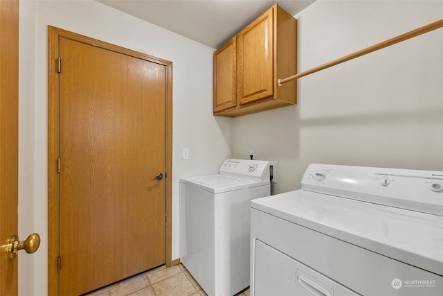 laundry room with cabinets, washer and dryer, and light tile patterned floors