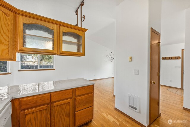 kitchen with track lighting, white dishwasher, and light wood-type flooring