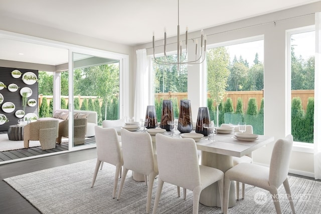 sunroom / solarium with a healthy amount of sunlight and a chandelier