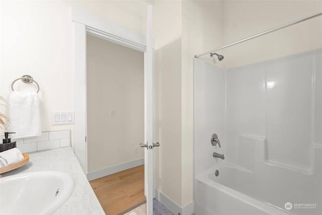 bathroom featuring vanity, wood-type flooring, and shower / bath combination