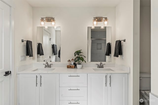 bathroom with vanity, toilet, and walk in shower