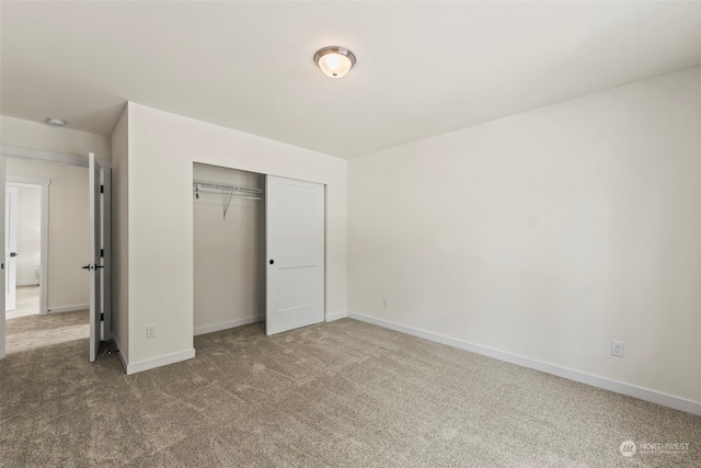 unfurnished bedroom featuring a closet and carpet floors