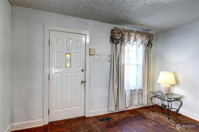 entrance foyer featuring a textured ceiling