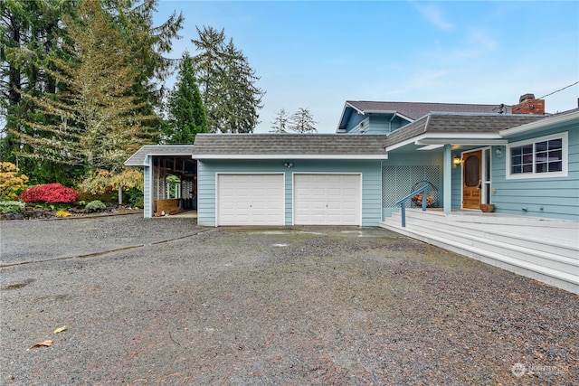 view of front facade featuring a garage and a carport