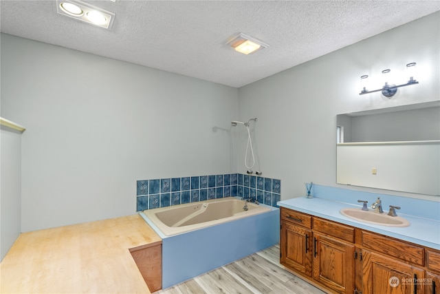 bathroom featuring vanity, a textured ceiling, independent shower and bath, and hardwood / wood-style flooring