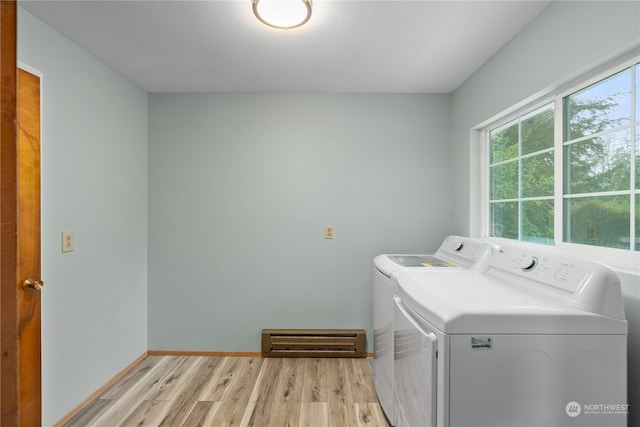 clothes washing area featuring light hardwood / wood-style flooring and separate washer and dryer