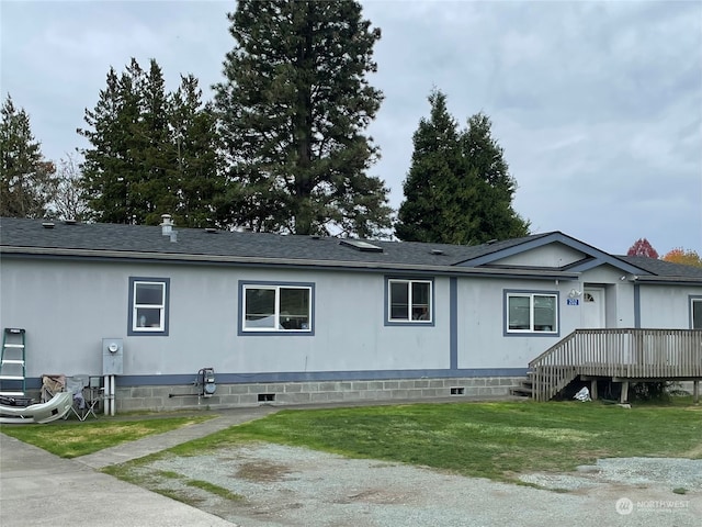 rear view of property featuring a deck and a yard