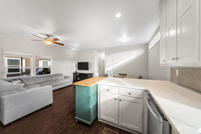 kitchen featuring dishwasher, a wealth of natural light, dark hardwood / wood-style floors, and white cabinets