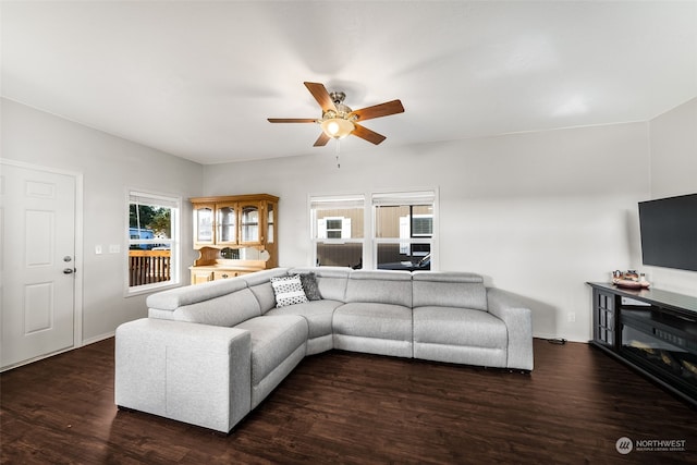 living room featuring dark wood-type flooring and ceiling fan