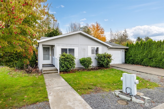 view of front of property with a front lawn and a garage