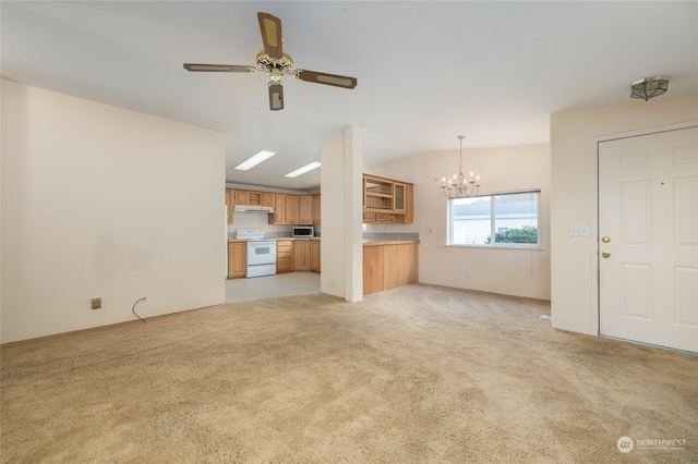 unfurnished living room featuring lofted ceiling, light carpet, and ceiling fan with notable chandelier