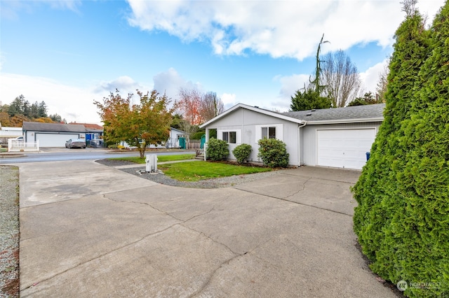 ranch-style house featuring a garage and a front yard