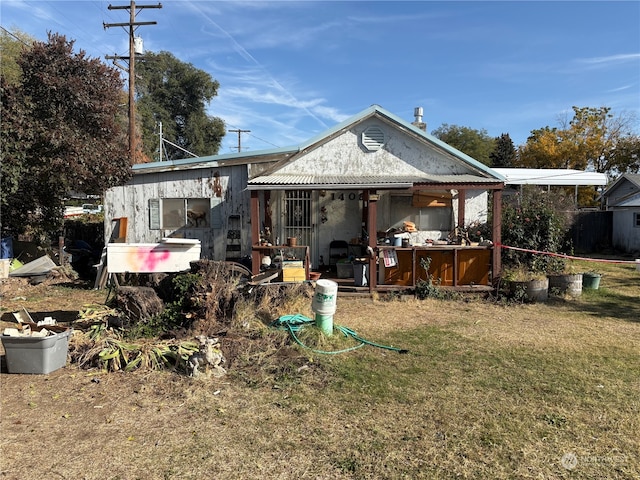 rear view of house with a lawn