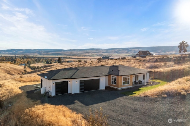 view of front of property with a mountain view and a garage