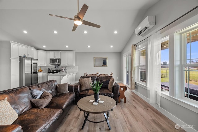 living area with ceiling fan, light wood finished floors, a wall mounted air conditioner, recessed lighting, and vaulted ceiling