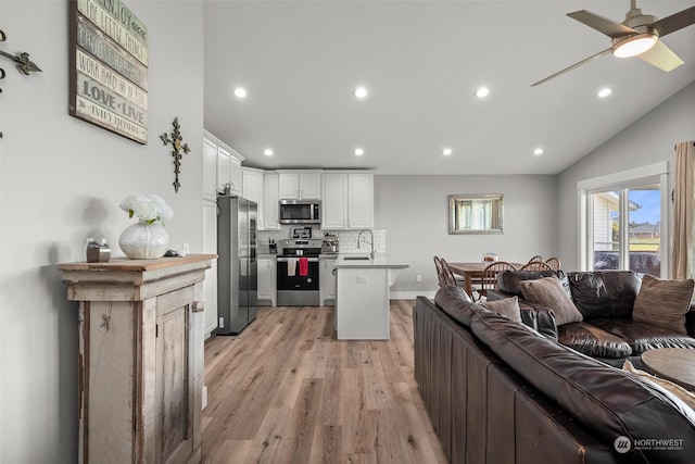 living room featuring recessed lighting, ceiling fan, and light wood-type flooring