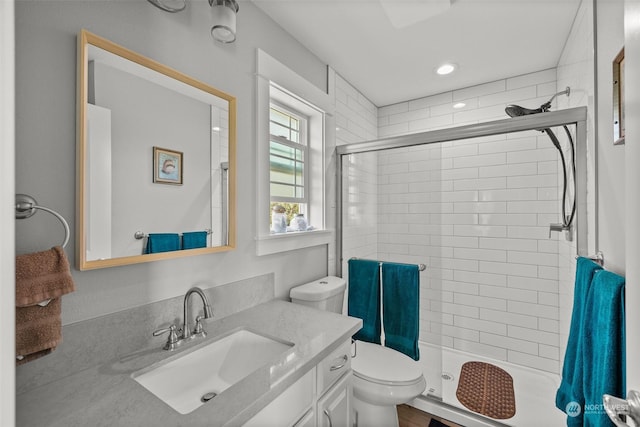 bathroom featuring vanity, a stall shower, and toilet