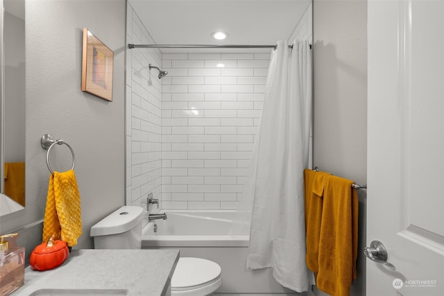 bathroom with recessed lighting, vanity, shower / bath combo, and toilet