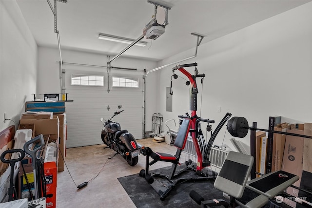 exercise room featuring electric panel and a garage