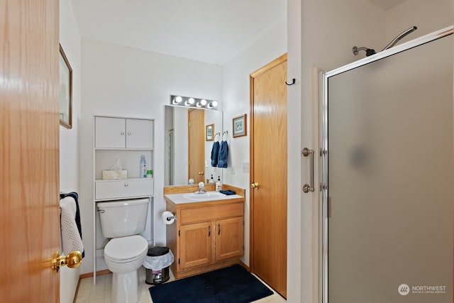 bathroom featuring a shower with door, vanity, toilet, and tile patterned floors