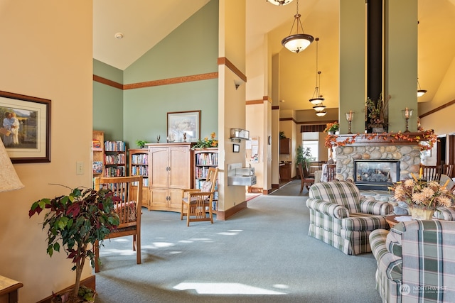 carpeted living room with a stone fireplace and high vaulted ceiling