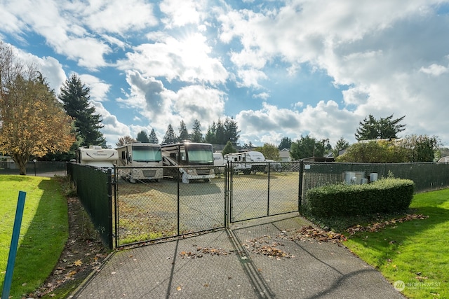 view of gate featuring a yard