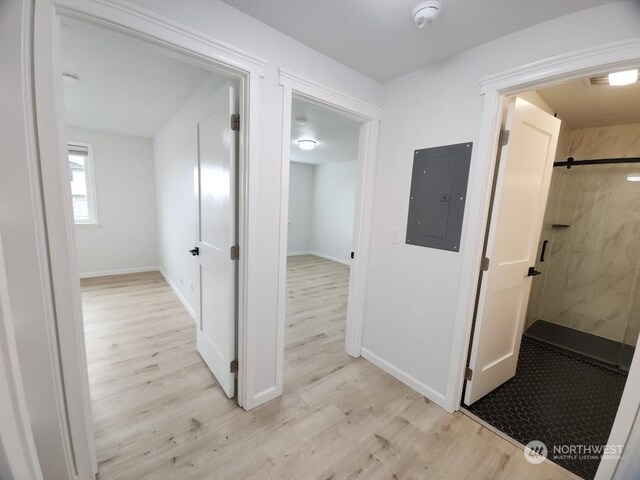 3600 Narrows View Ln Unit 201, Bremerton, WA 98310 - hallway featuring electric panel, light wood-style flooring, and baseboards