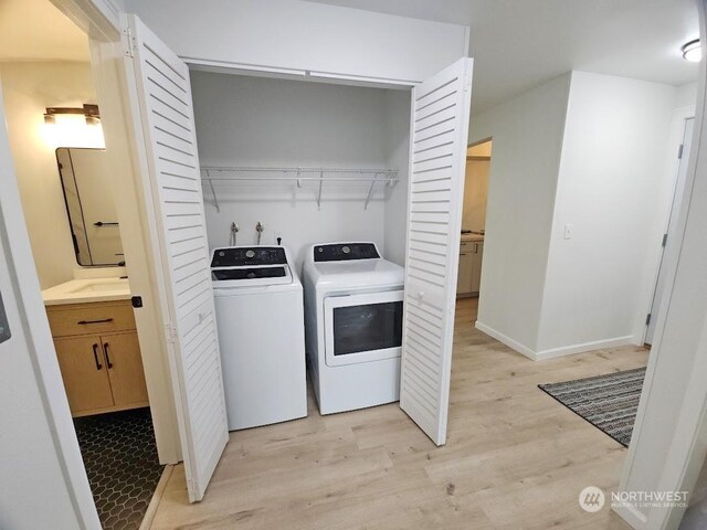 3600 Narrows View Ln Unit 201, Bremerton, WA 98310 - laundry area featuring independent washer and dryer, light wood finished floors, and baseboards