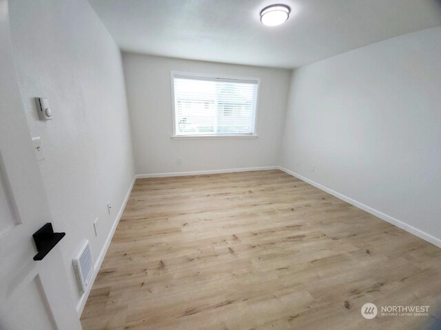 3600 Narrows View Ln Unit 201, Bremerton, WA 98310 - empty room with light wood-style floors and baseboards