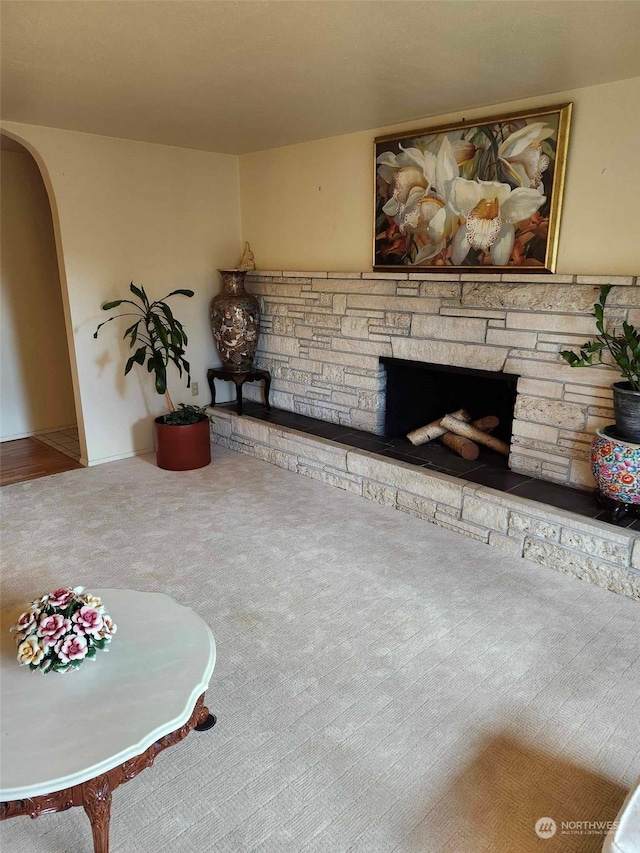 unfurnished living room featuring a fireplace and carpet