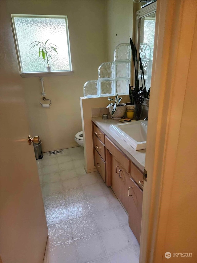 bathroom featuring vanity and toilet