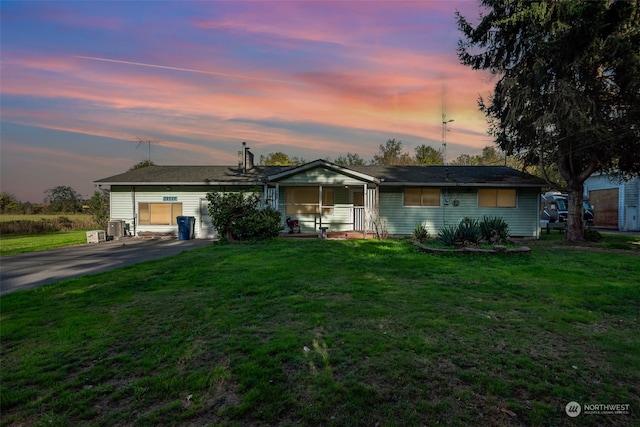 ranch-style home featuring a lawn