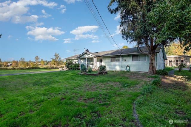 back of house featuring a yard