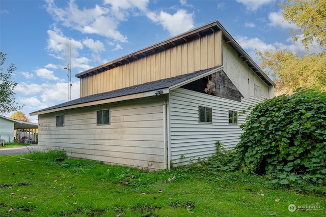 view of side of property with a yard