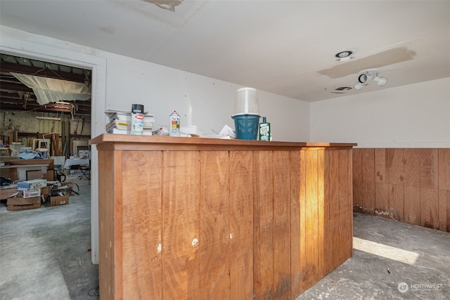 bar with wooden walls and concrete floors