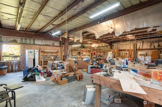 garage with white fridge and a workshop area