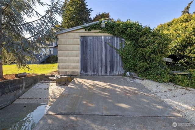 view of outdoor structure featuring a lawn