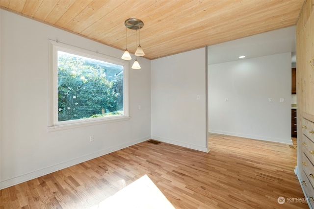 unfurnished dining area with wood ceiling, plenty of natural light, and light wood-type flooring