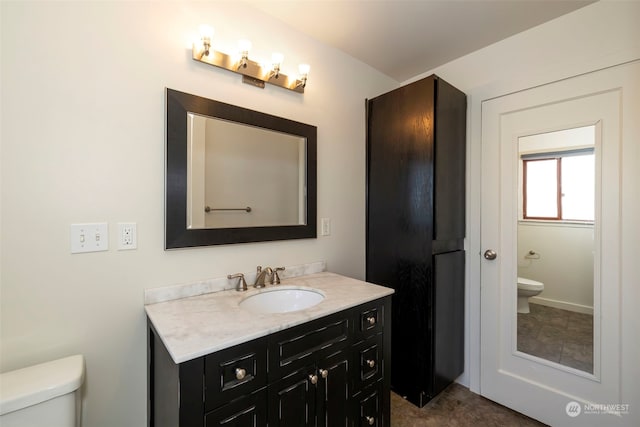 bathroom with toilet and vanity