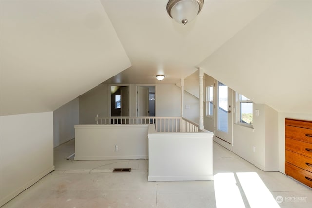 additional living space featuring lofted ceiling