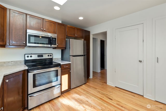 kitchen with light hardwood / wood-style flooring and stainless steel appliances