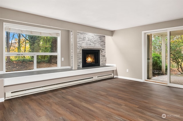 unfurnished living room featuring a baseboard radiator, dark wood-type flooring, and a fireplace