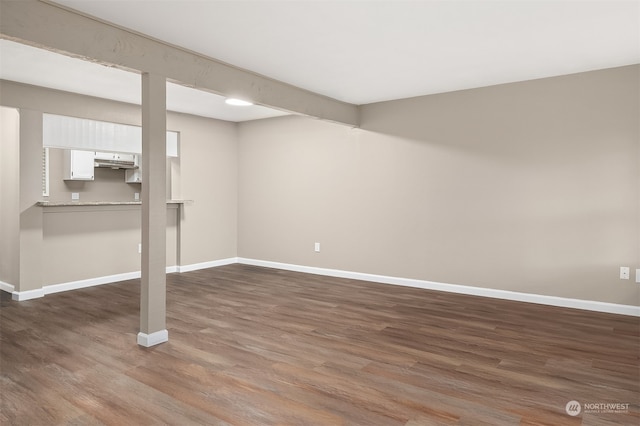 basement featuring dark hardwood / wood-style flooring