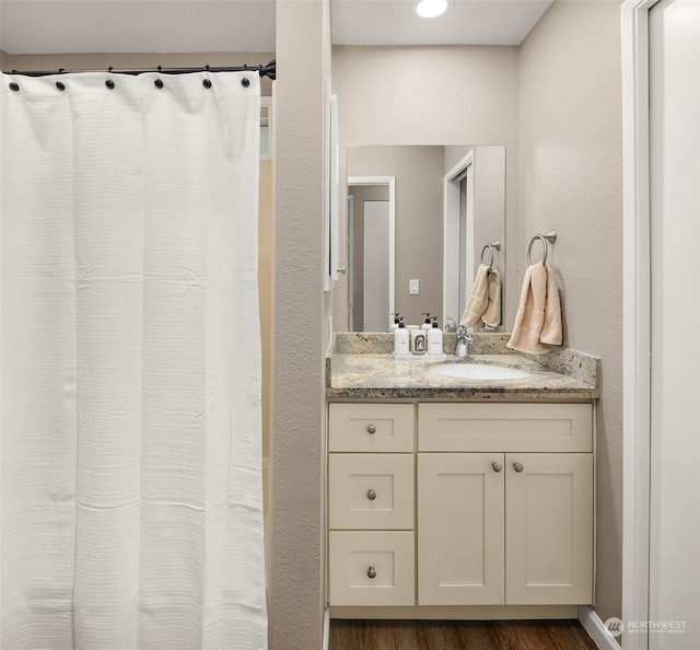 bathroom with vanity and hardwood / wood-style flooring