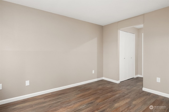 empty room featuring dark wood-type flooring