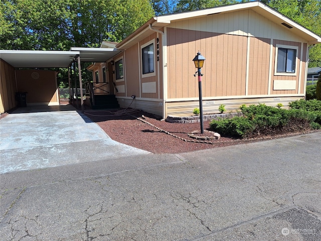 view of side of home with a carport