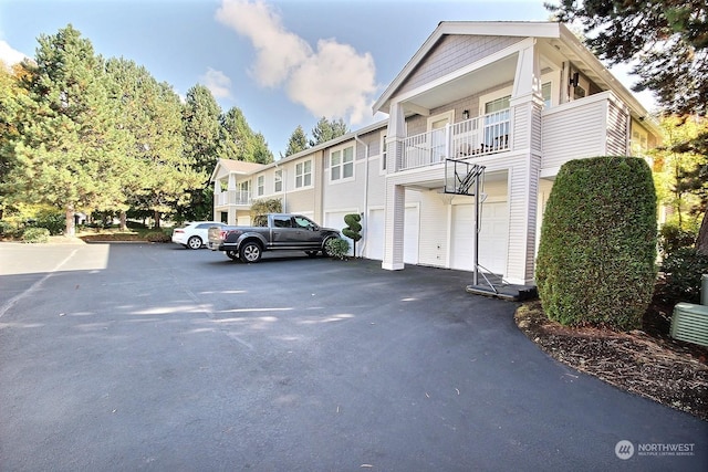 exterior space featuring a garage and a balcony