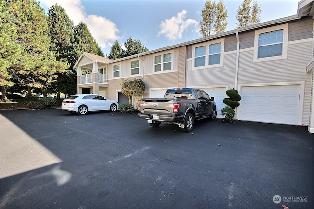 multi unit property with a balcony and a garage