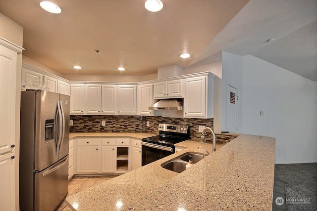 kitchen featuring appliances with stainless steel finishes, sink, kitchen peninsula, white cabinets, and light stone counters