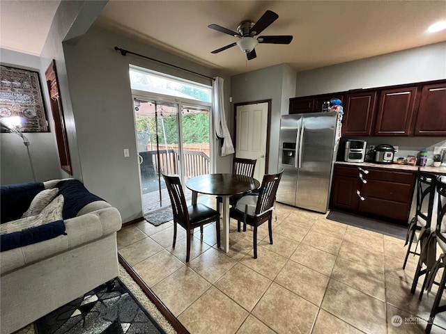 tiled dining space featuring ceiling fan